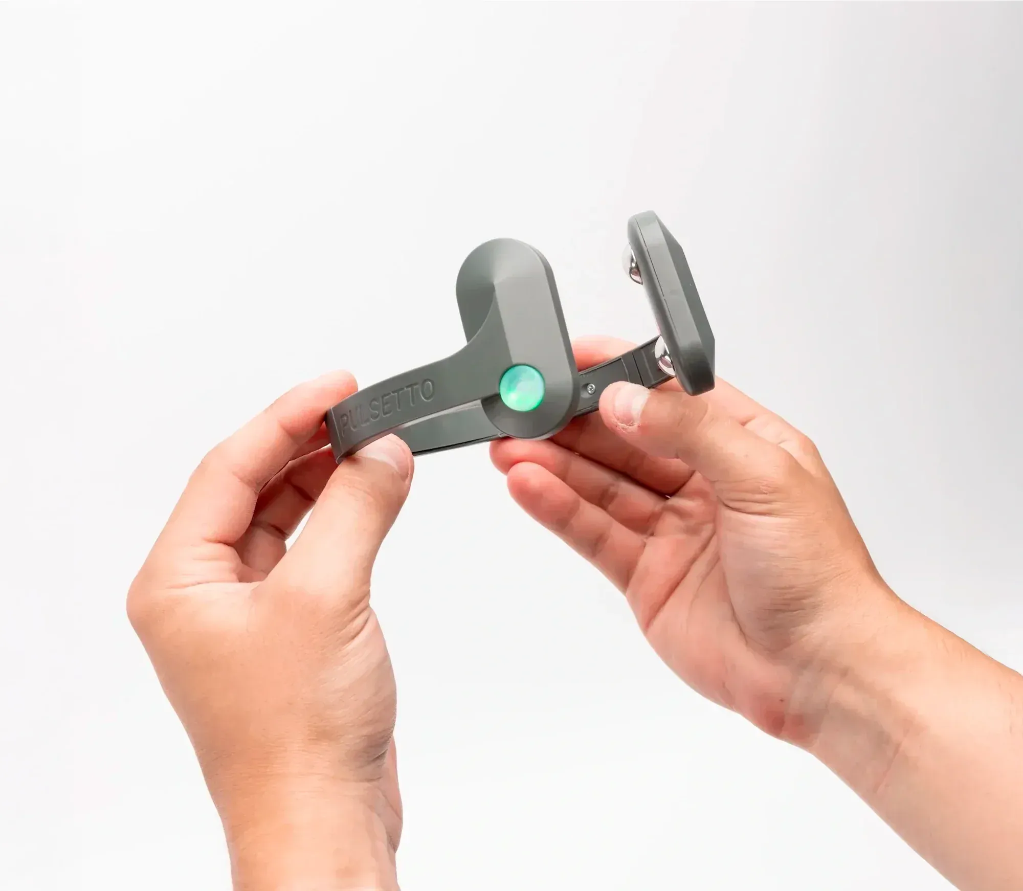 Hands holding the open Pulsetto FIT device before placing it around the neck